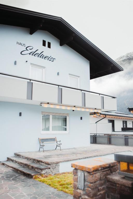 a building with a bench in front of it at Haus Edelweiss in Tarrenz
