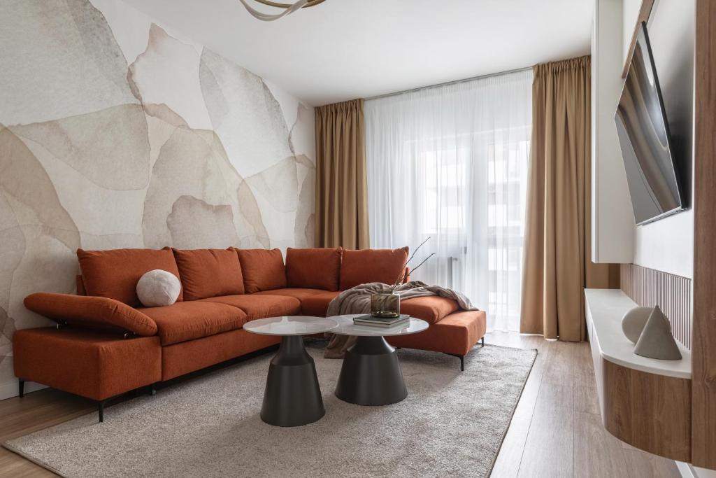 a living room with a couch and a table at The Aristocrat by D'or Selection in Bucharest