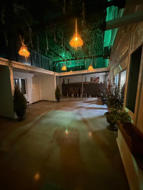 a large room with a table and some lights at Başkent Otel in Mudanya