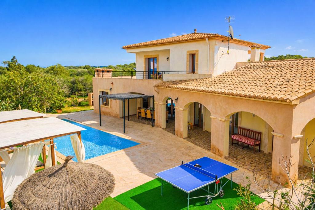 a villa with a swimming pool and a house at E227 Sa Pedrera by Mallorca Villa Selection in Caʼs Concos