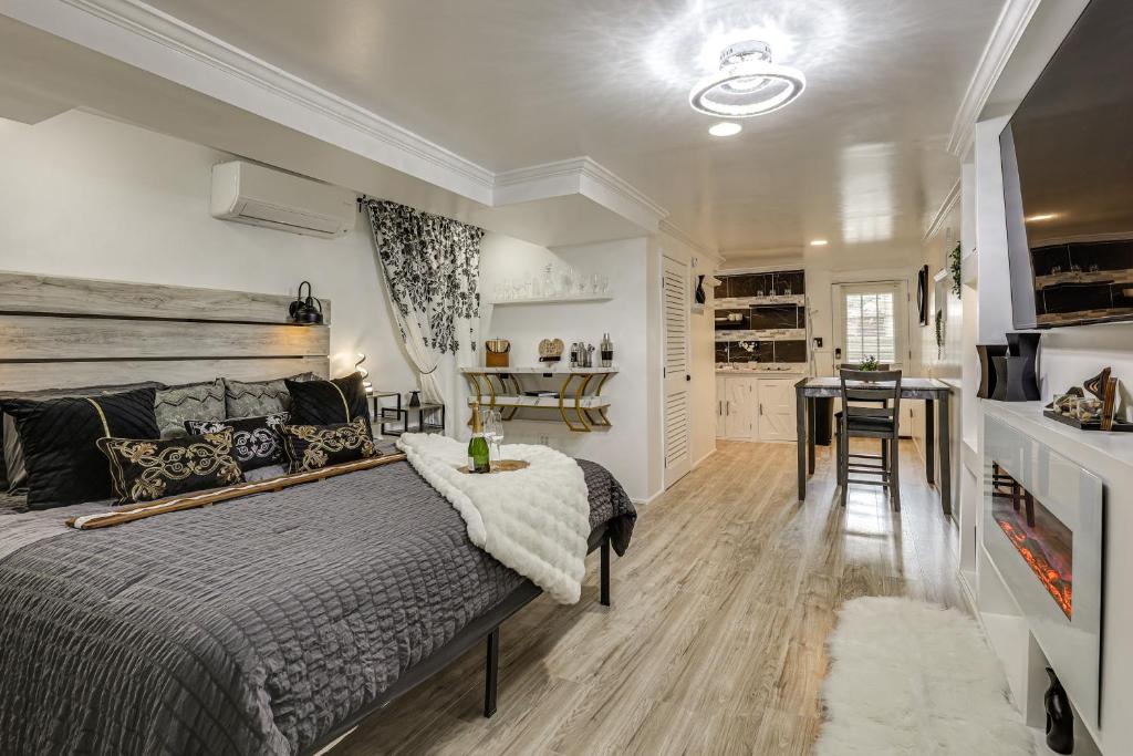 a bedroom with a bed and a table and a kitchen at Oasis Hideaway Apt w/ Rainforest Shower! in Baltimore