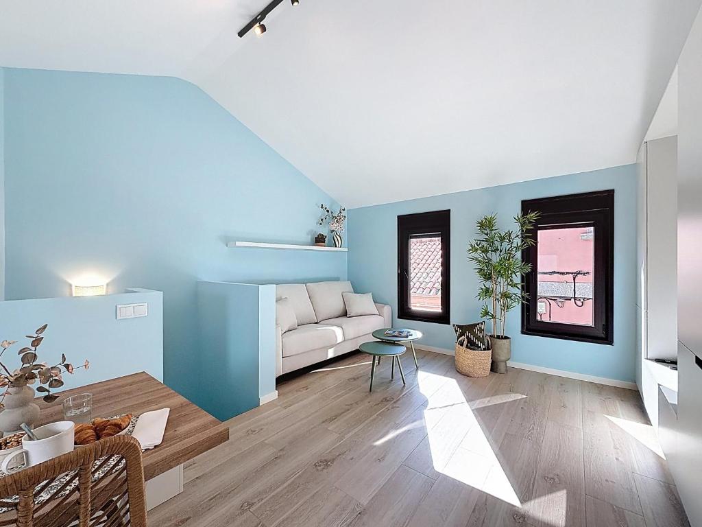 a living room with a white couch and blue walls at Casa PedraParda in O Grove