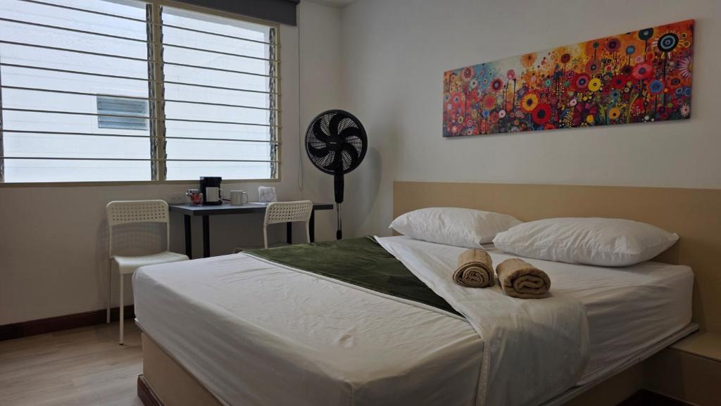 a bedroom with a bed with two towels on it at ABC-53 Housing in Medellín