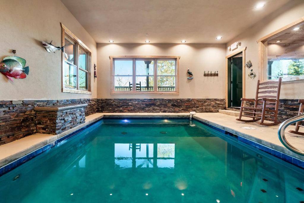 a swimming pool in a house at Massive Cabin Indoor Pool Driving Simulators Sleeps 20 in Gatlinburg