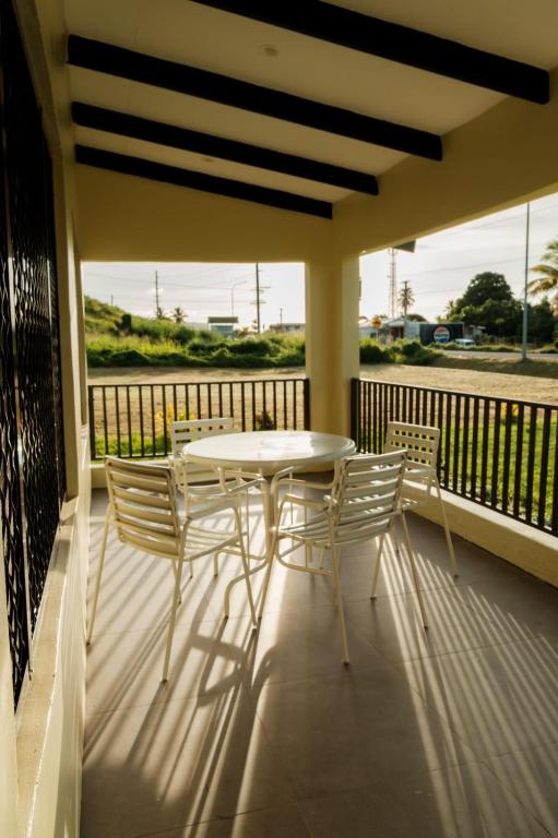 a porch with a table and chairs on a balcony at Raluve BnB in Rakiraki