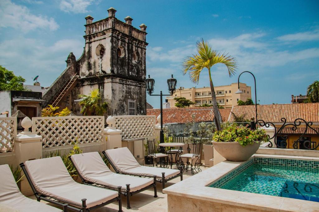 a patio with chairs and a swimming pool at Estrella de San Pedro by Zakher in Cartagena de Indias