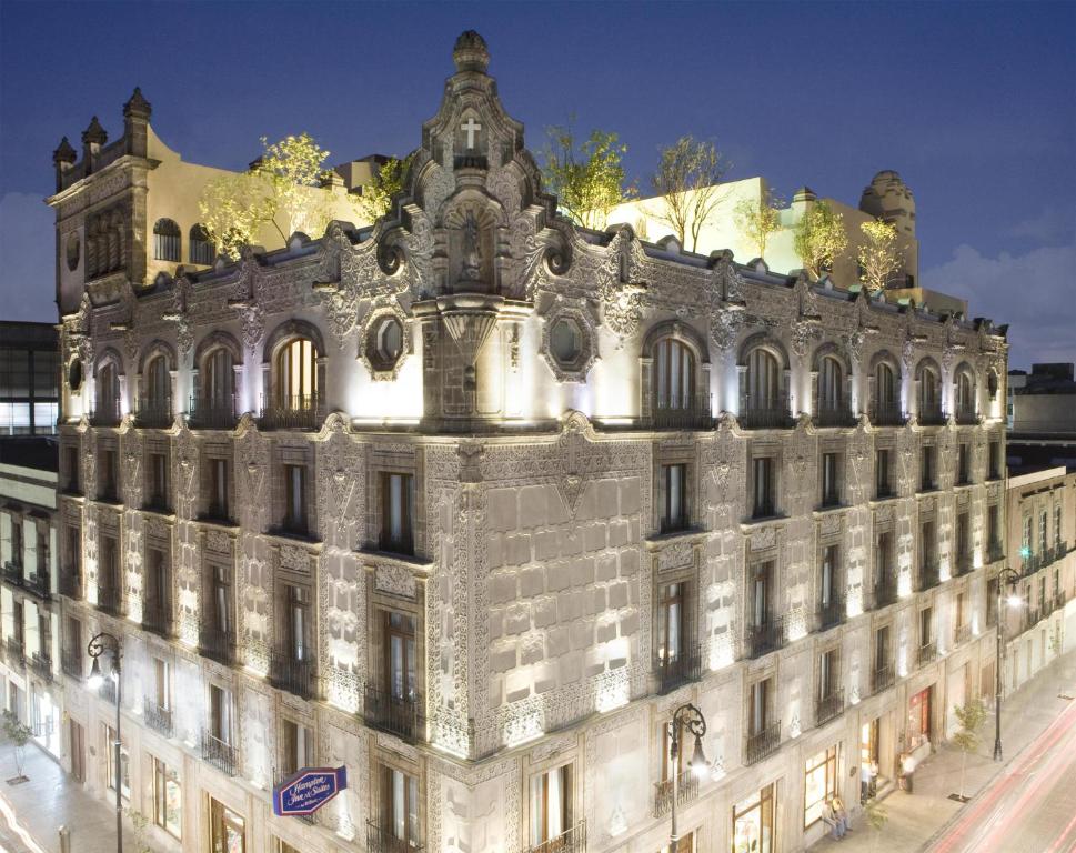 a large building with lights on top of it at Hampton Inn & Suites Mexico City - Centro Historico in Mexico City