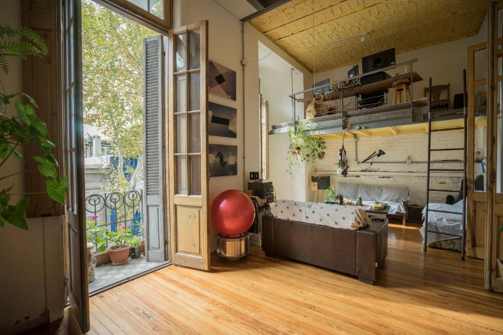 a living room with a couch and a large window at Casa compartida de Santi in Montevideo
