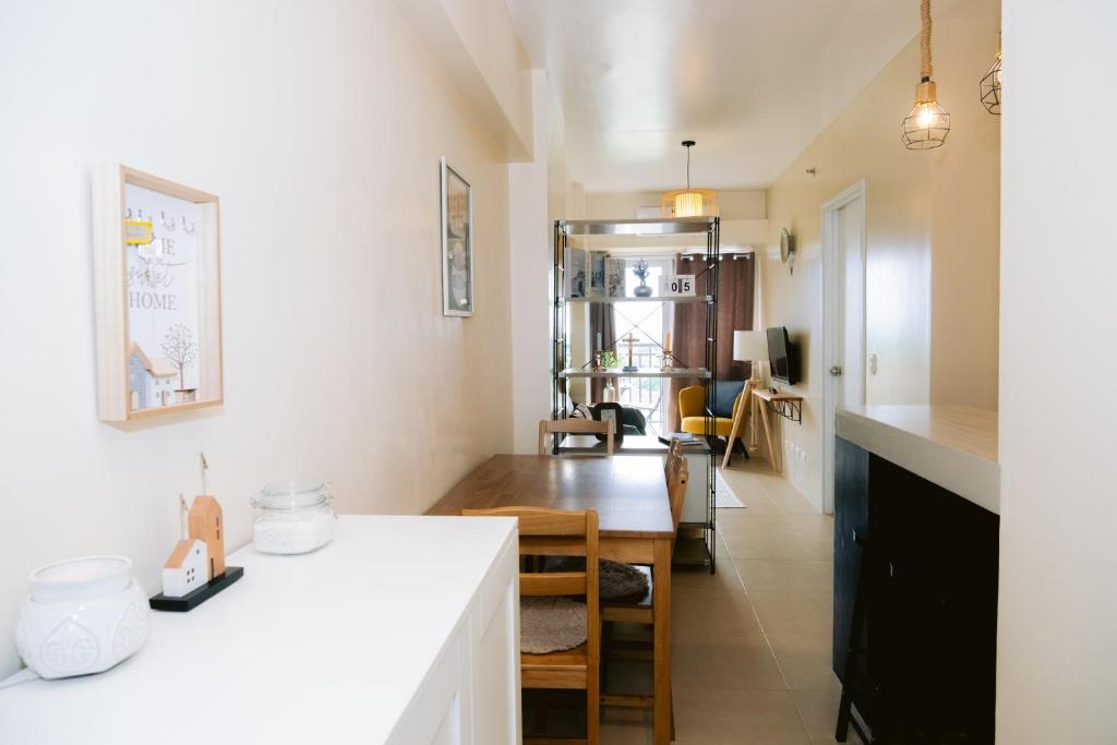 a kitchen and living room with a table and chairs at Tahanan in Iloilo City