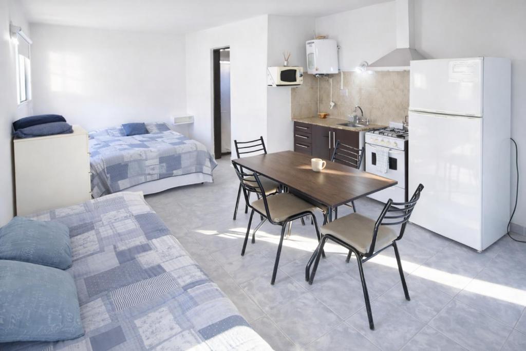 a kitchen and dining room with a table and chairs at Gotas de Rocío - Balcón para 4 in San Antonio Oeste