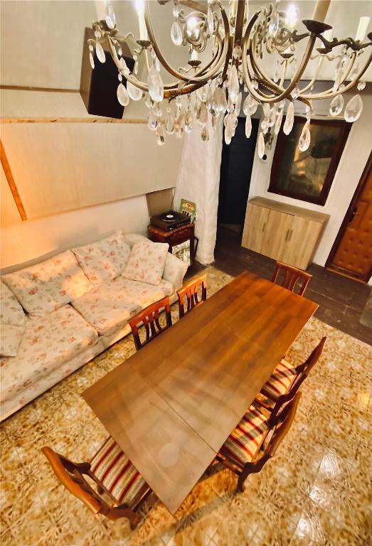 a dining room with a table and a couch at Vojko Holidays - Rustika in Koper