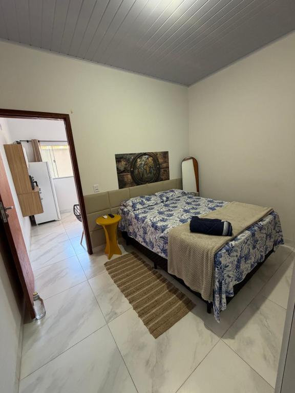a bedroom with a bed and a door to a kitchen at VivaVida boungavilli 01 in Sinop