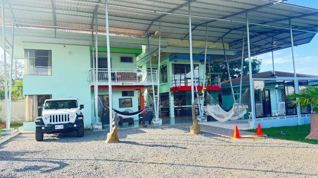a truck parked in front of a building with swings at Villas Lux Arenal in Fortuna