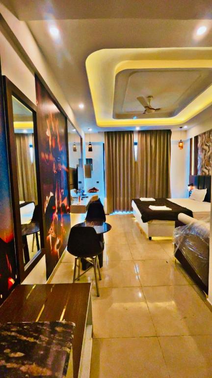 a living room with a bed and a couch and chairs at Omaxe Lucknow Luxury Home in Nalmatha