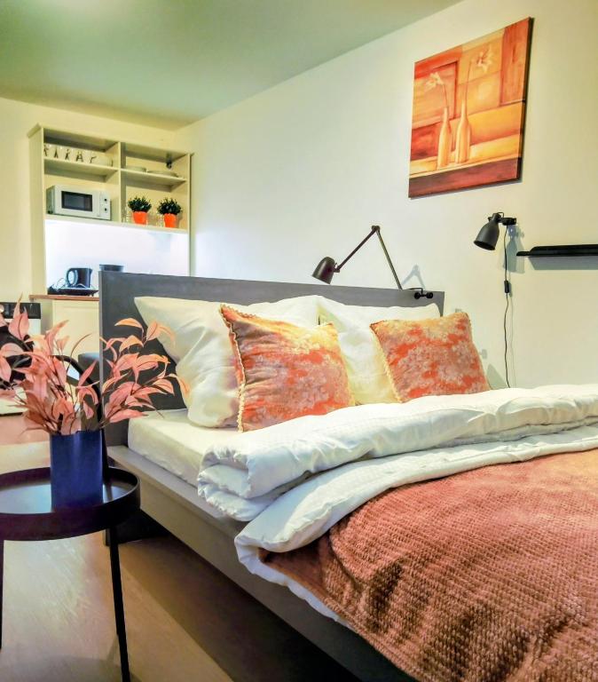 a bed with pillows on it in a room at Langenfeld City Apartment in Langenfeld
