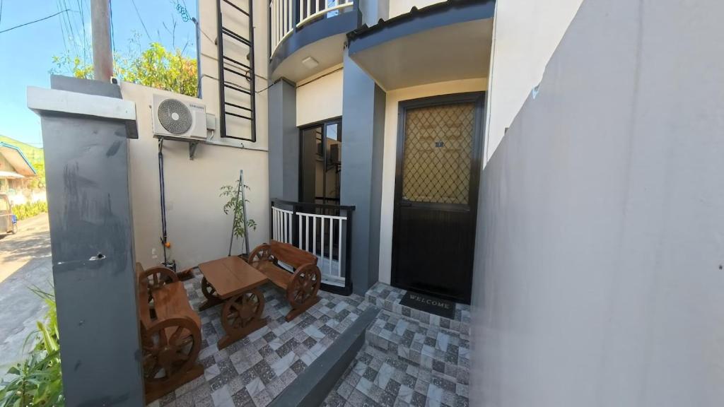 a front door of a house with a bench at CLBC Residences 1A in Ibaba
