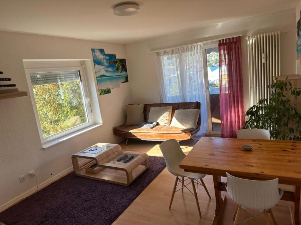 a living room with a table and a couch at Cosy Apartment in Aadorf