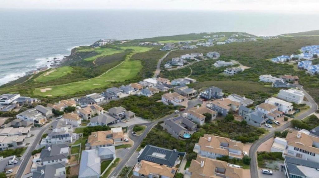 an aerial view of a residential neighborhood next to the ocean at Pinnacle Golf Estate Haven in Mossel Bay