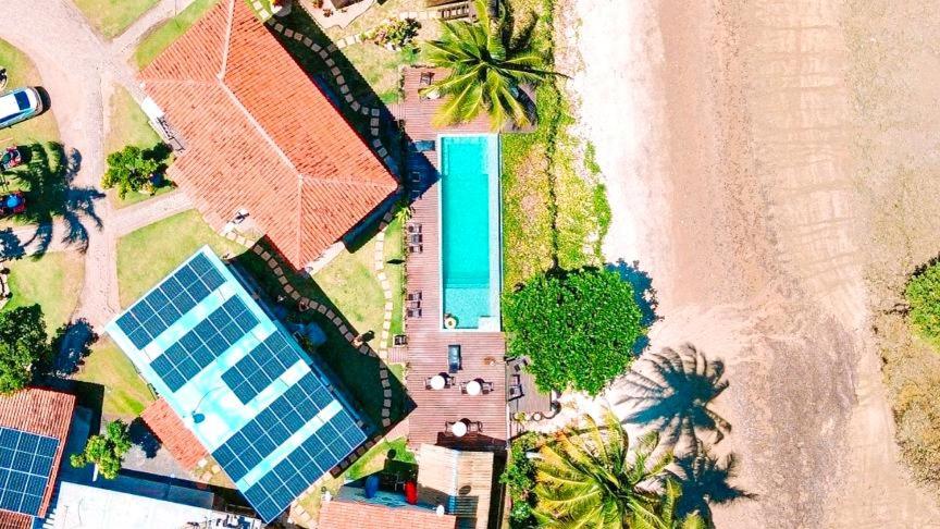 an overhead view of a pool on a beach at Pousada Boa Sorte in Cumuruxatiba