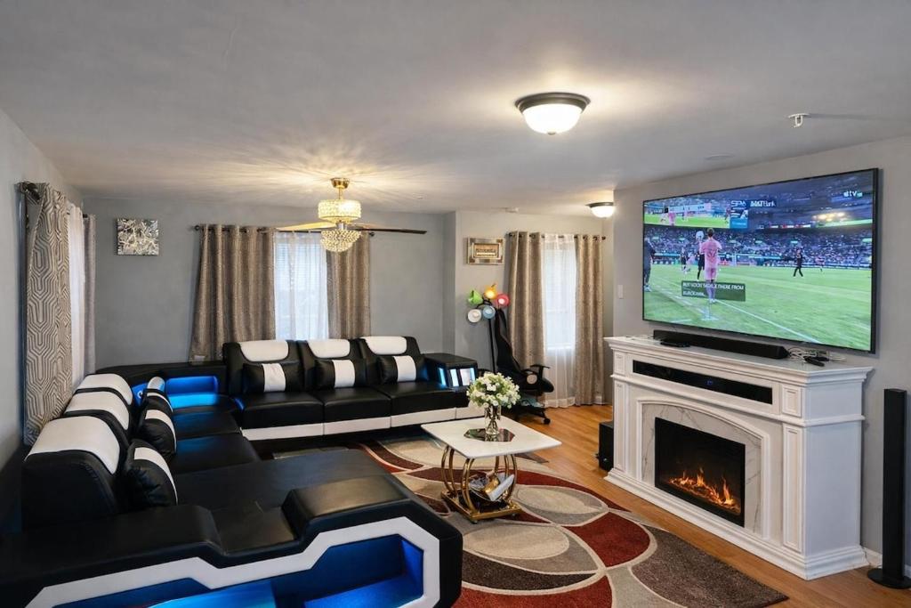a living room with a couch and a tv at Spacious 3 bedroom duplex home inside Worcester in Worcester