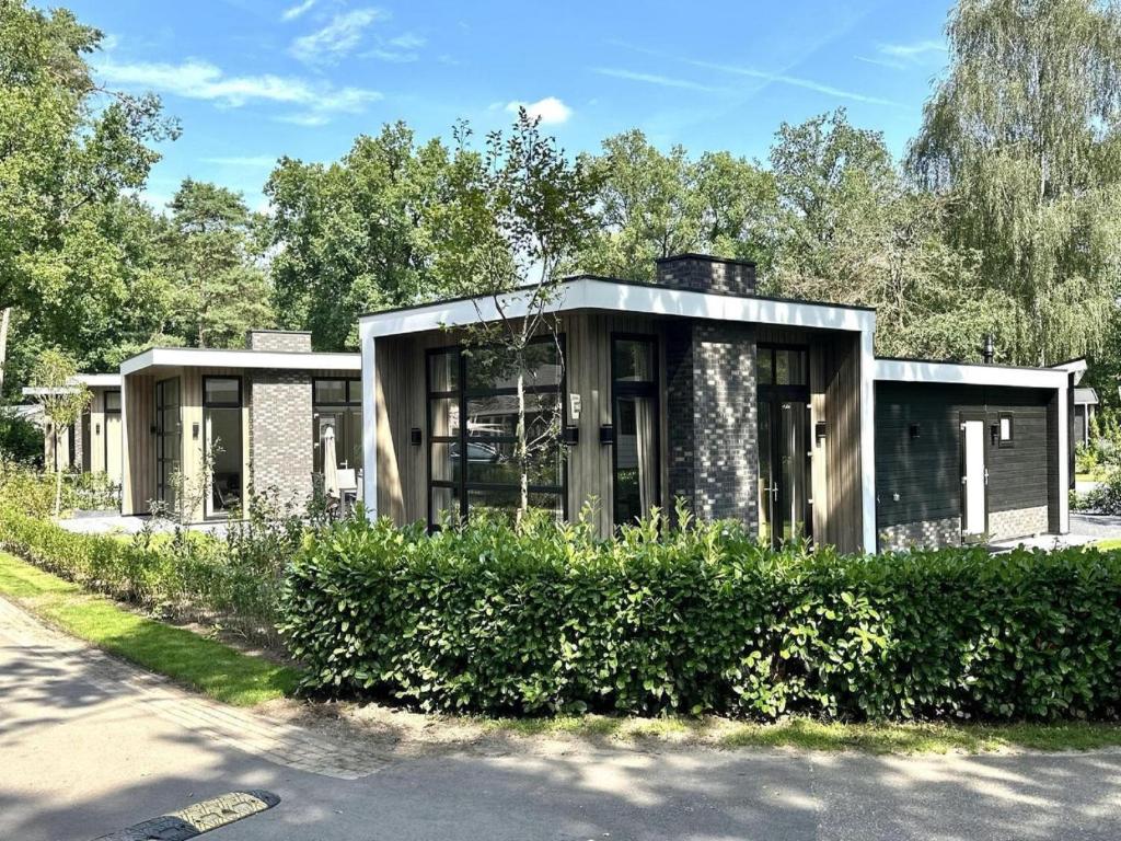 a house on the side of a road at Nature Park Chalet in Hoenderloo in Hoenderloo