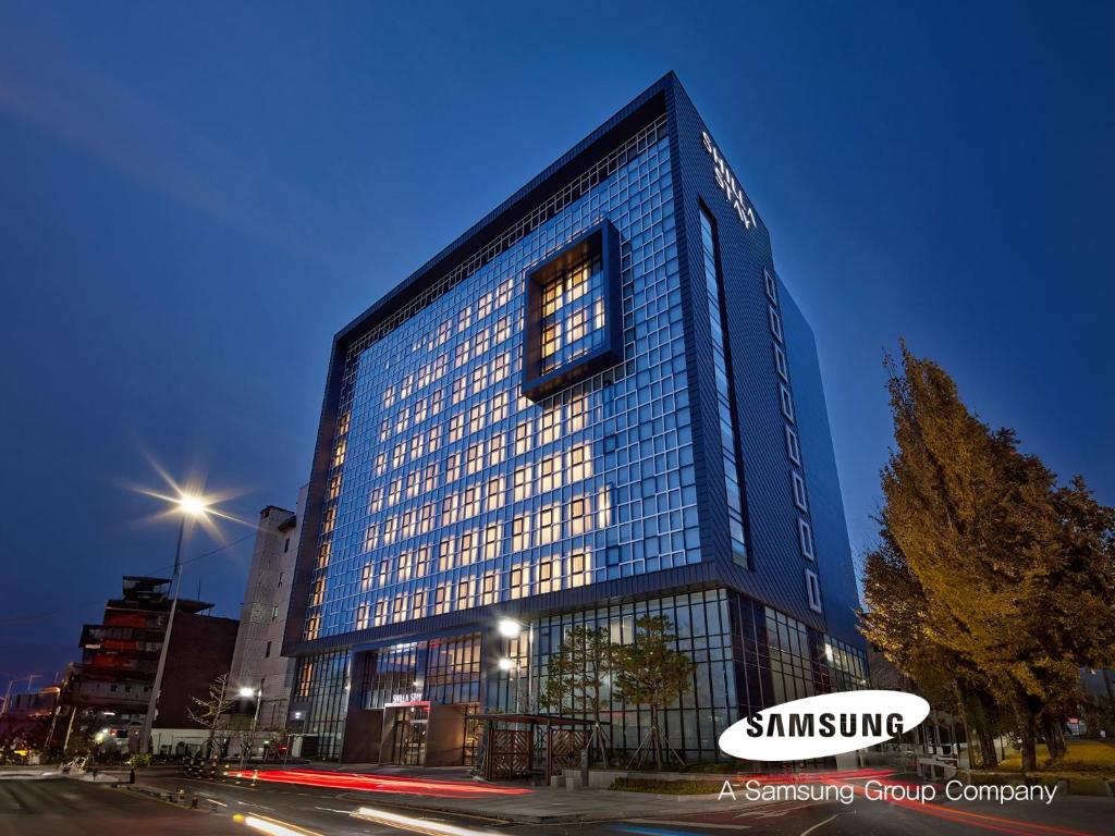 a tall blue building with its lights on at Shilla Stay Jeonju Hanok Village in Jeonju