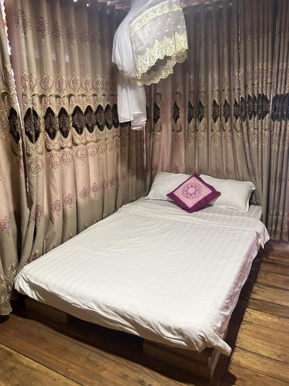 a bed with a purple pillow on top of it at ANOR - Farmstay - Double bed in Ha Tia