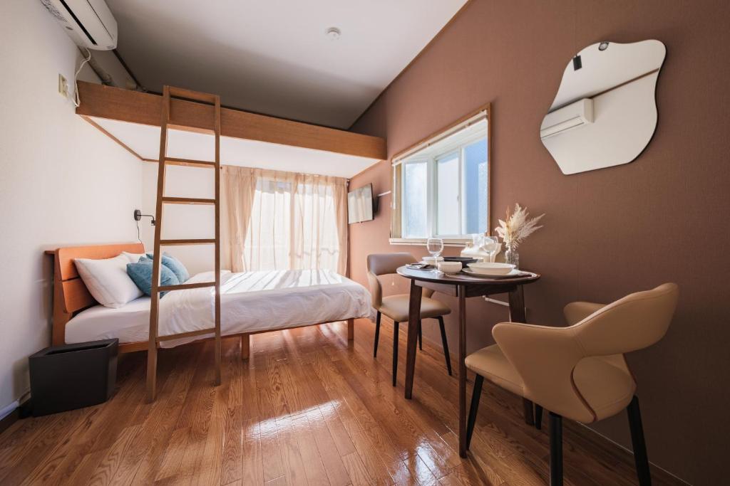 a bedroom with a bunk bed and a table at 茜 Akane in Kawasaki