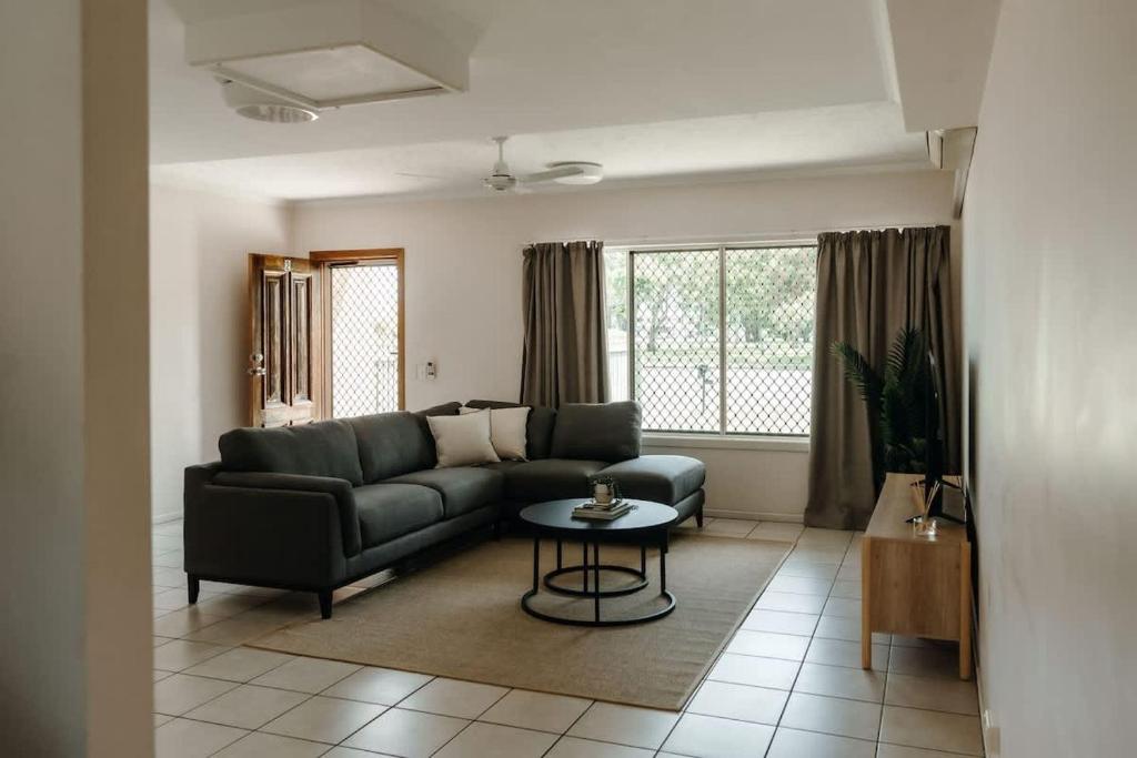 a living room with a couch and a table at Unit 2, Rocky CBD in Rockhampton