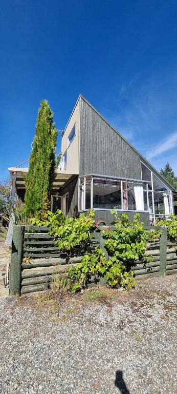 a house with a bunch of plants in front of it at Waypoint Lodge in Naseby