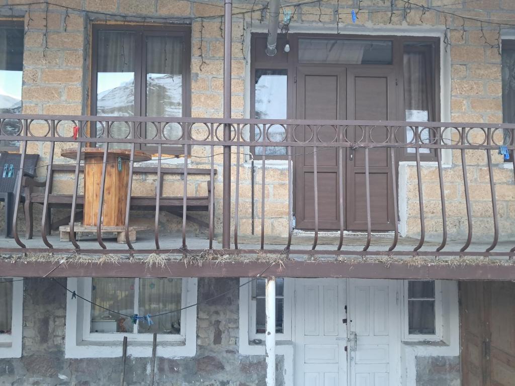 a balcony of a building with a door and windows at Hotel Kazbegi11 in Ach'khoti
