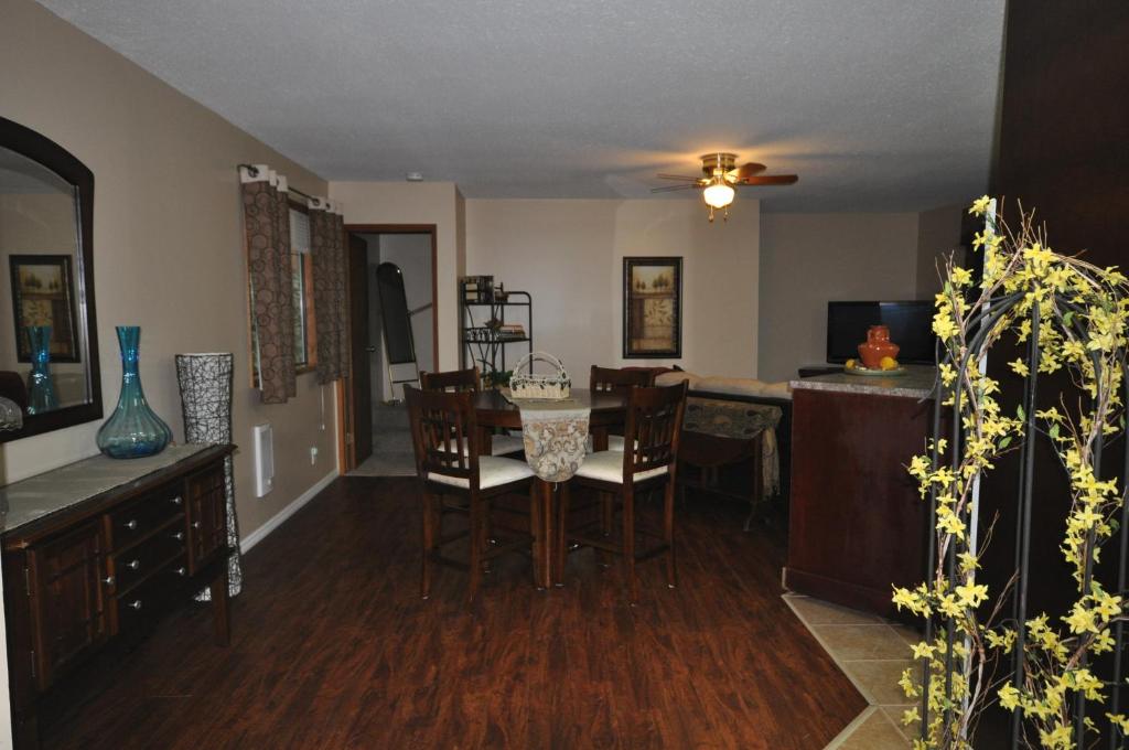 a kitchen and dining room with a table and chairs at Garden House in Courtenay