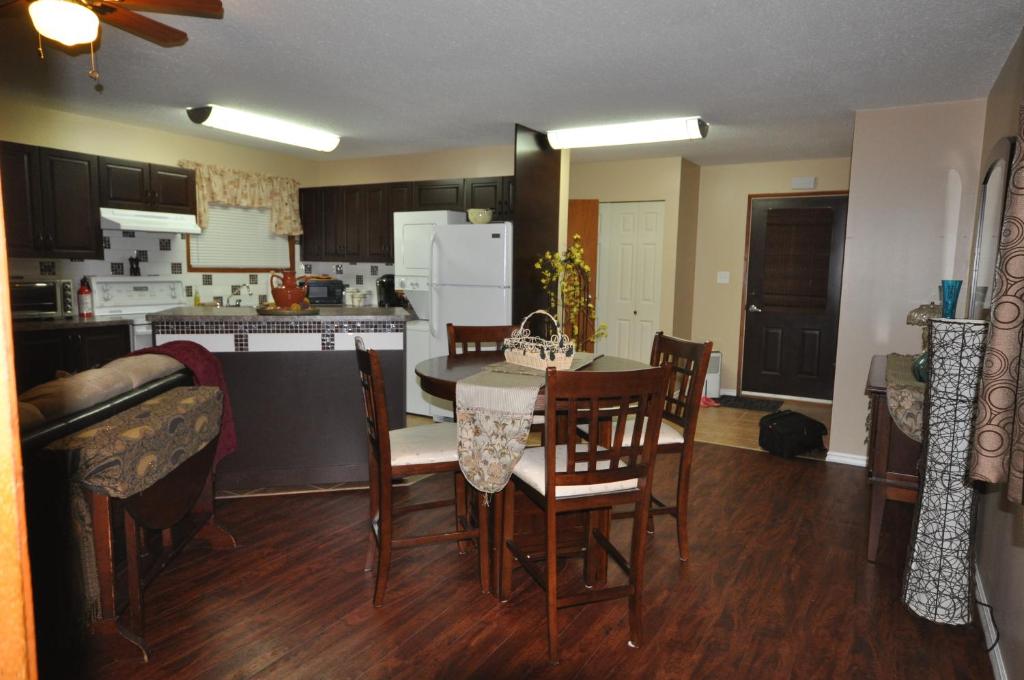 a kitchen and dining room with a table and chairs at Garden House in Courtenay