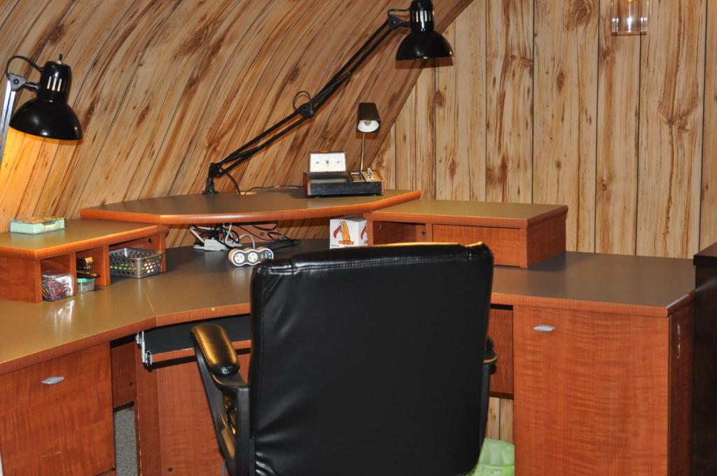 an office with a black chair at a desk at Garden House in Courtenay