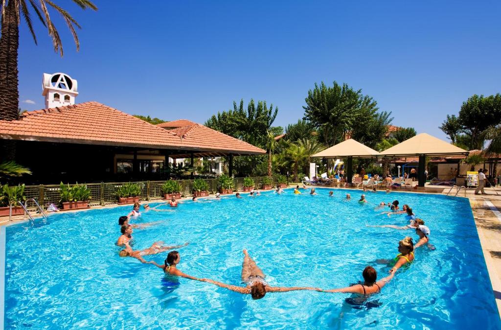 a group of people in a pool at a resort at Marvıda Hotel Akman Park in Kemer