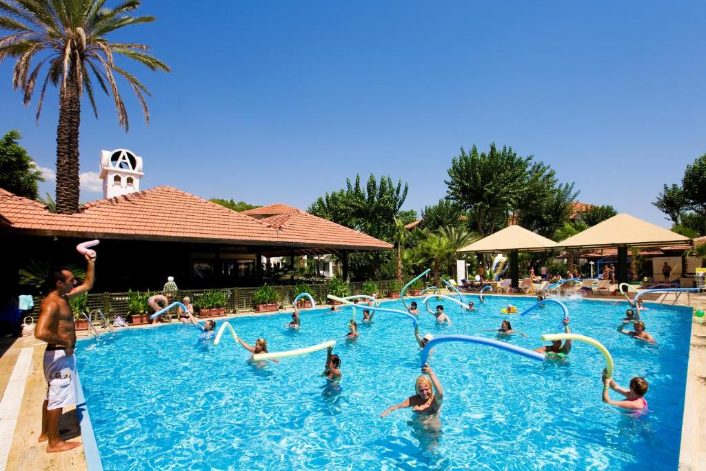 a group of people playing in a swimming pool at Marvıda Hotel Akman Park in Kemer