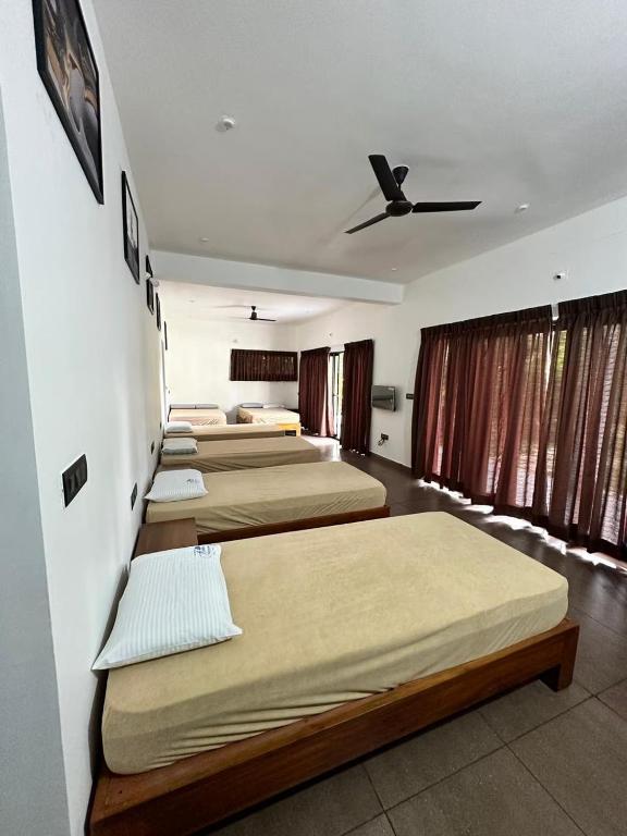 a group of four beds in a room at Aarna the Baane in SanivÄrsante
