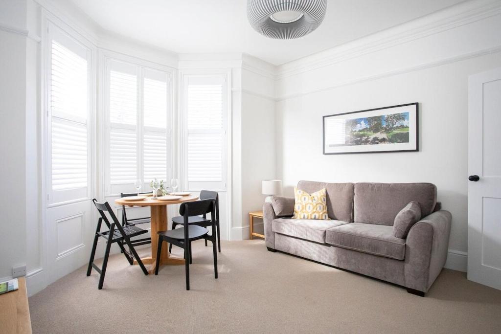 a living room with a couch and a table at Pebble Hideaway in Worthing