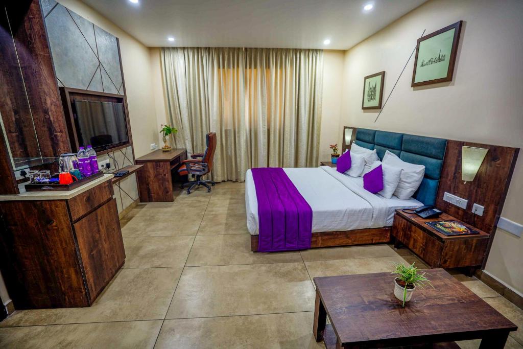 a large hotel room with a bed and a table at Anna Residency The Quintessential Boutique Hotel in Pondicherry