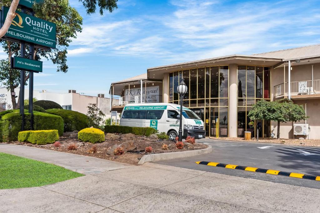 a white van parked in front of a building at Quality Hotel Melbourne Airport in Melbourne