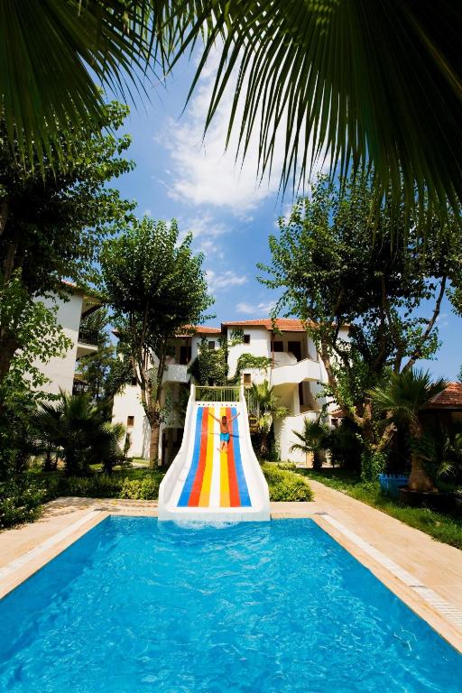 a colorful inflatable slide in a swimming pool at Marvıda Hotel Akman Park in Kemer