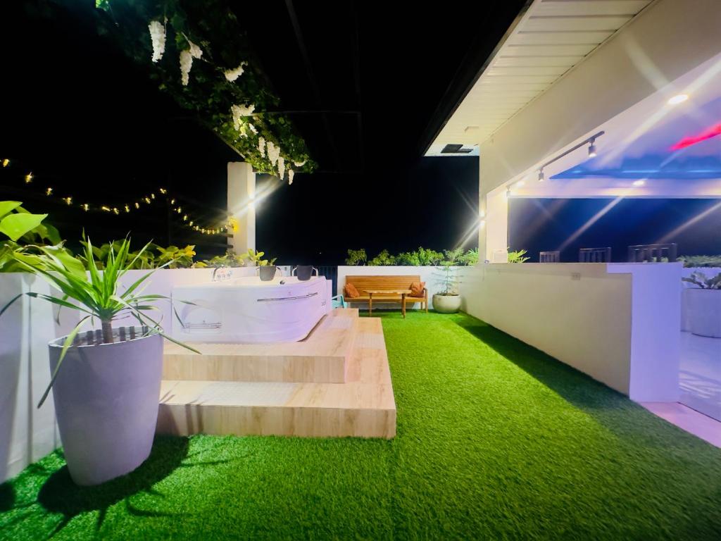 a room with stairs and a bath tub and grass at The Penthouse With Outdoor Jacuzzi Private Rooftop Solar Powered Energy in Puerto Princesa City