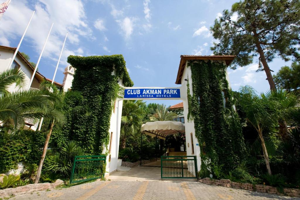 a gate at the entrance to a building with ivy at Marvıda Hotel Akman Park in Kemer