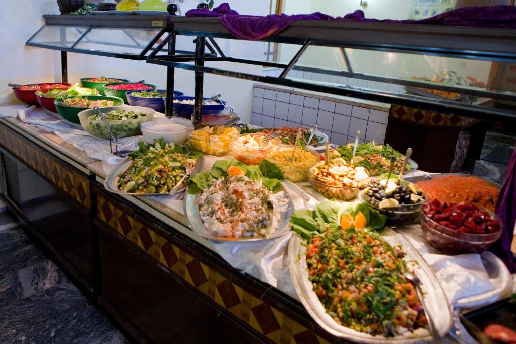 a buffet with many different food items on a table at Marvıda Hotel Akman Park in Kemer