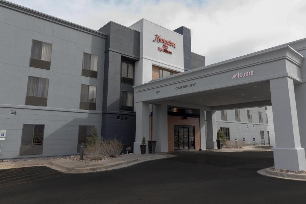 a hotel building with a sign on the front of it at Hampton Inn Rock Springs in Rock Springs