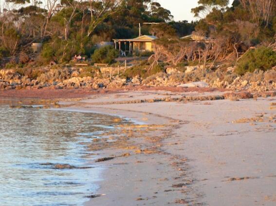 a beach with a gazebo in the background at The Beach House, Kangaroo Island in Baudin Beach