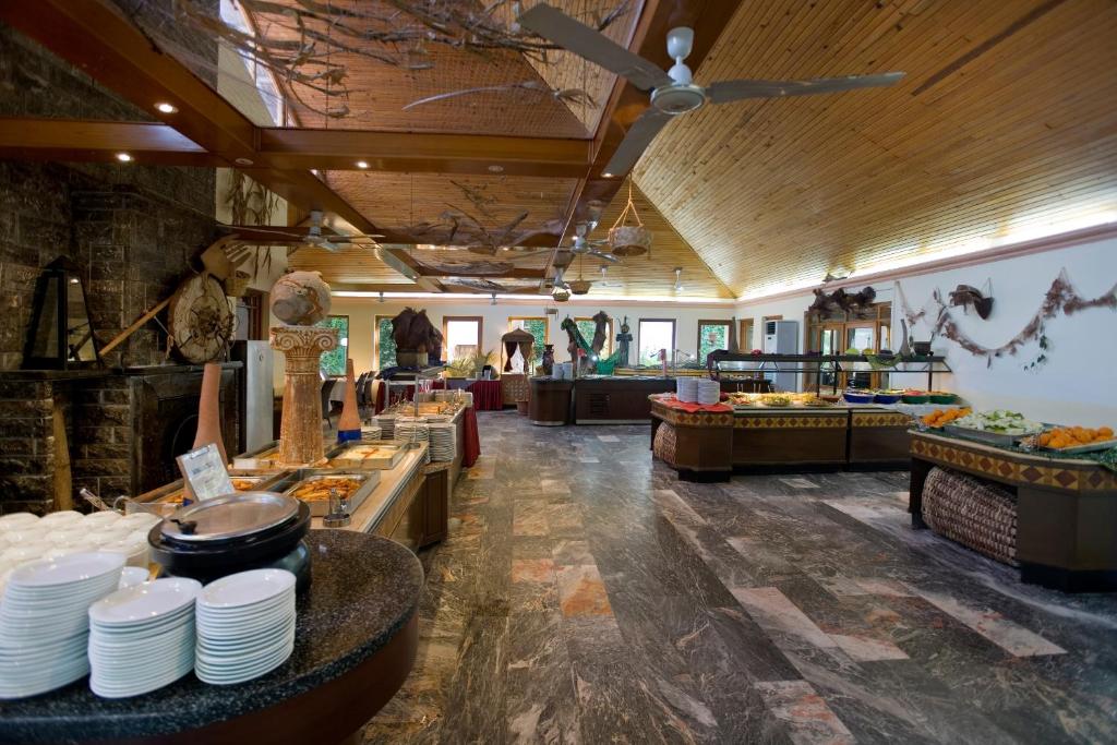 a restaurant with plates and other food on display at Marvıda Hotel Akman Park in Kemer