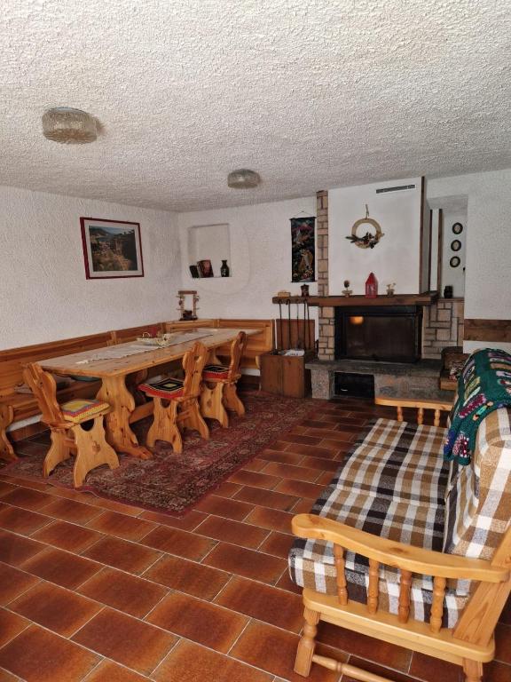 a living room with a large wooden table and chairs at maso denis in Canale San Bovo