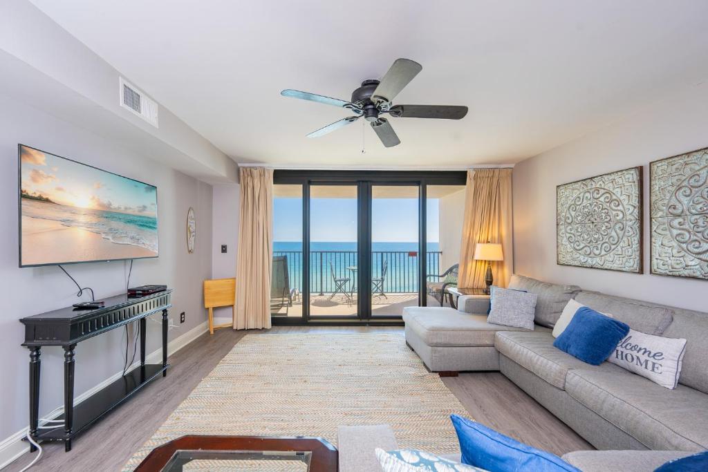 a living room with a couch and a ceiling fan at Wind Drift 604S condo in Orange Beach