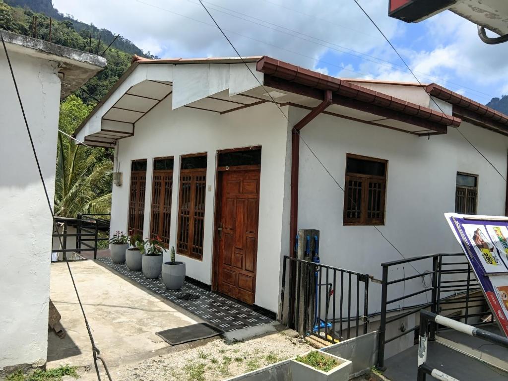 a house under construction with a wooden door at Three D Rooms in Haldummulla